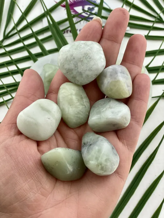 Jade tumble stone, held in the hand
