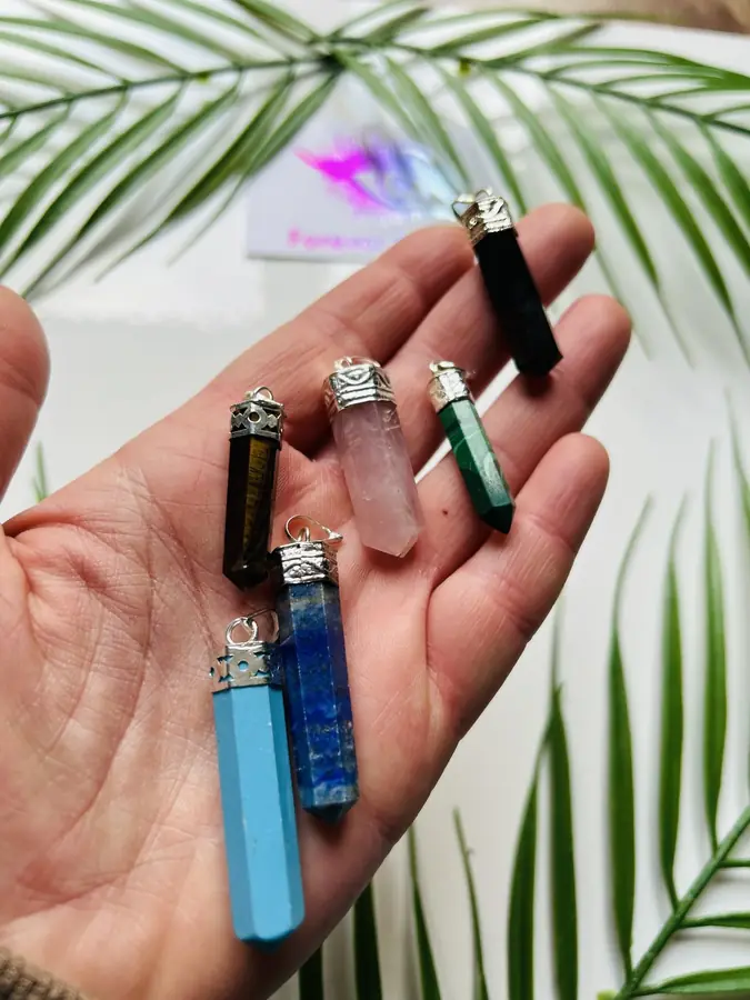 Crystal point pendants, held in the hand