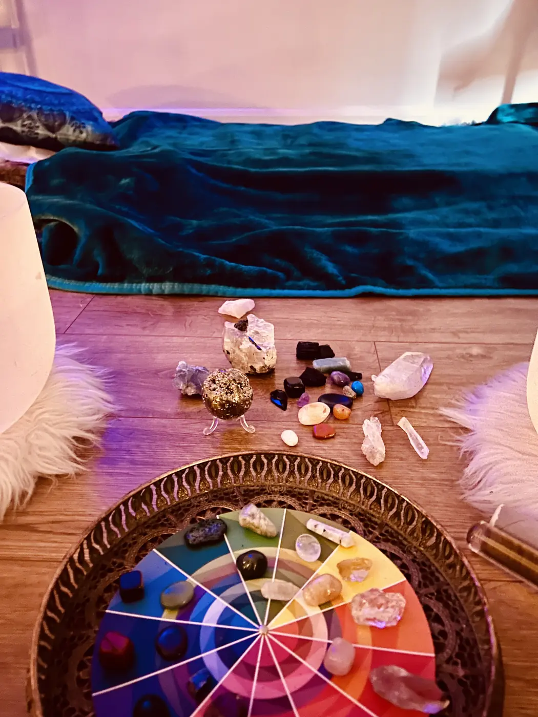 A chakra colour wheel laid with crystals on the cabin floor