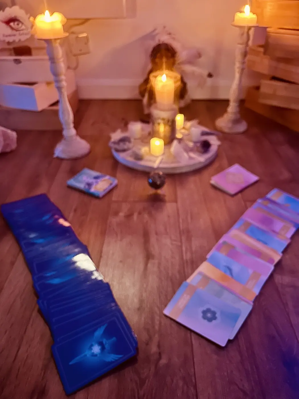 Oracle cards fanned out on the cabin floor by candlelight